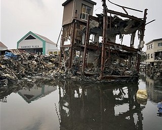 A building damaged by the March 11 earthquake and tsunami stands still in Kesennuma, Miyagi Prefecture, Japan, Sunday, March 20, 2011. 