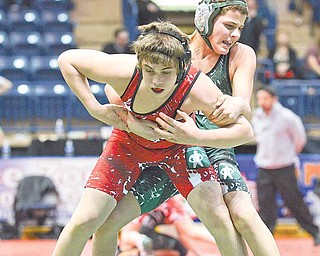 Tony Bannister (red), 12, of Wauseon, wrestles Stephan Gilbert, 12, of North Canton (green) at the Covelli Center Sunday evening. Bannister won the match.