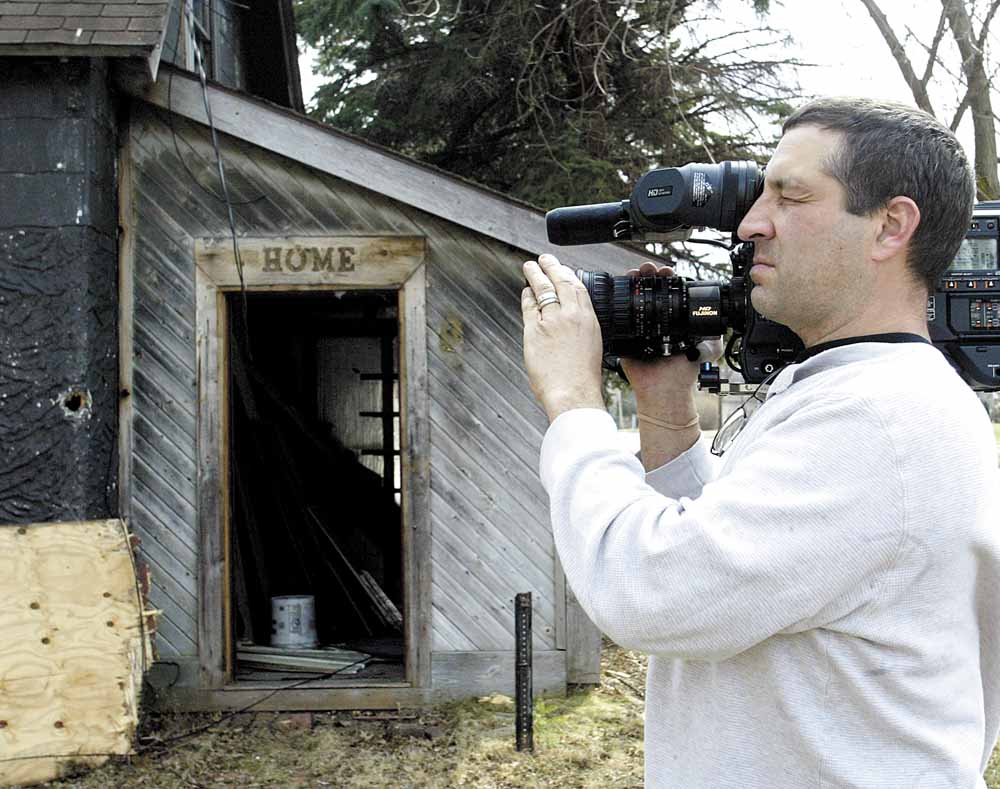Videographer Andy Fredericks records the demolition of a vacant house on Firnley Avenue on Youngstown’s South Side. Blueprint America began more than three years ago and examines the nation’s public infrastructure.