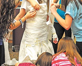 Jena Yambrovich gets a toilet paper wedding dress from her fellow South Range High School classmates at a Sisterhood Project event. The Sisterhood Project acts as a support group for freshman girls by integrating them with members of the senior class.