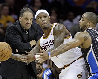 Orlando Magic head coach Stan Van Gundy, left, watches as Magic's Jameer Nelson (14) puts pressure on Cleveland Cavaliers' Daniel Gibson (1) in the fourth quarter of an NBA basketball game, Monday, March 21, 2011, in Cleveland. The Magic won 97-86. 