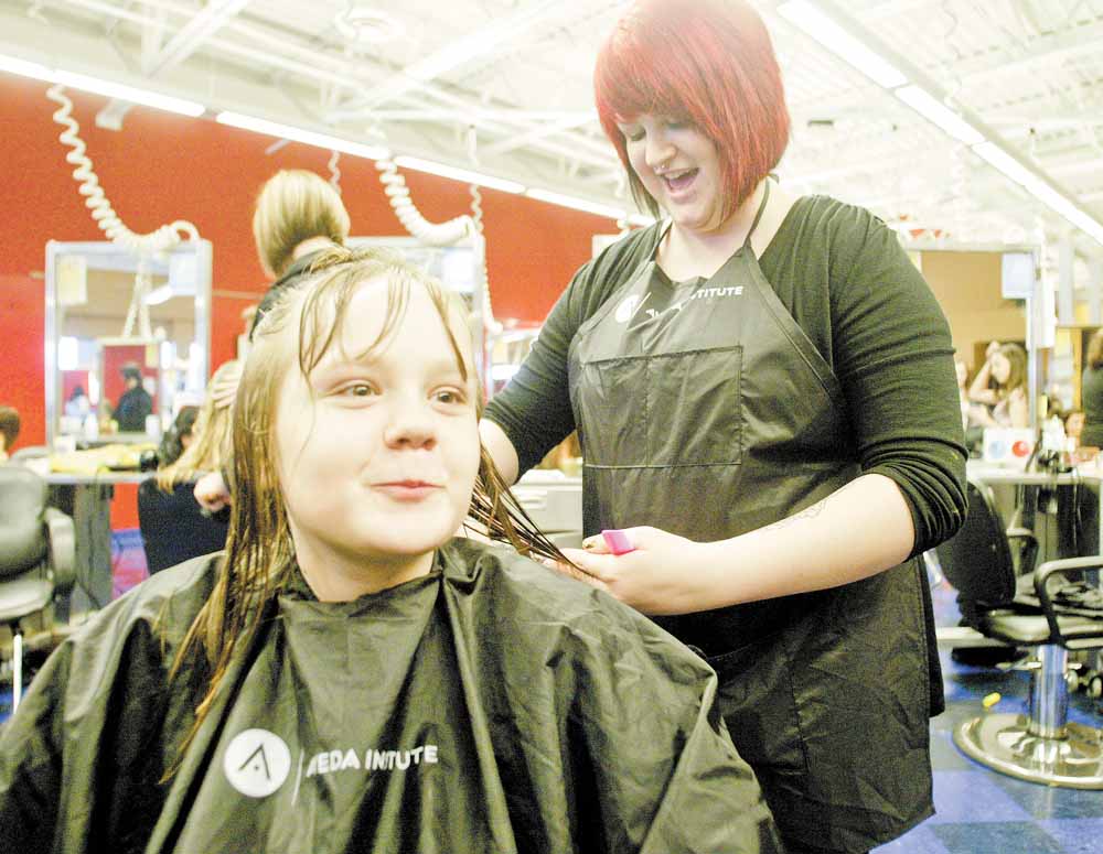 Trinity Benitez, 10, of Austintown, gets a new ‘do from Aveda Institute cosmetologist Kelly VanKirk. Thirty girls in grades four through six from the Austintown Local School District were pampered Tuesday at an event organized by the Angels For Kids Foundation