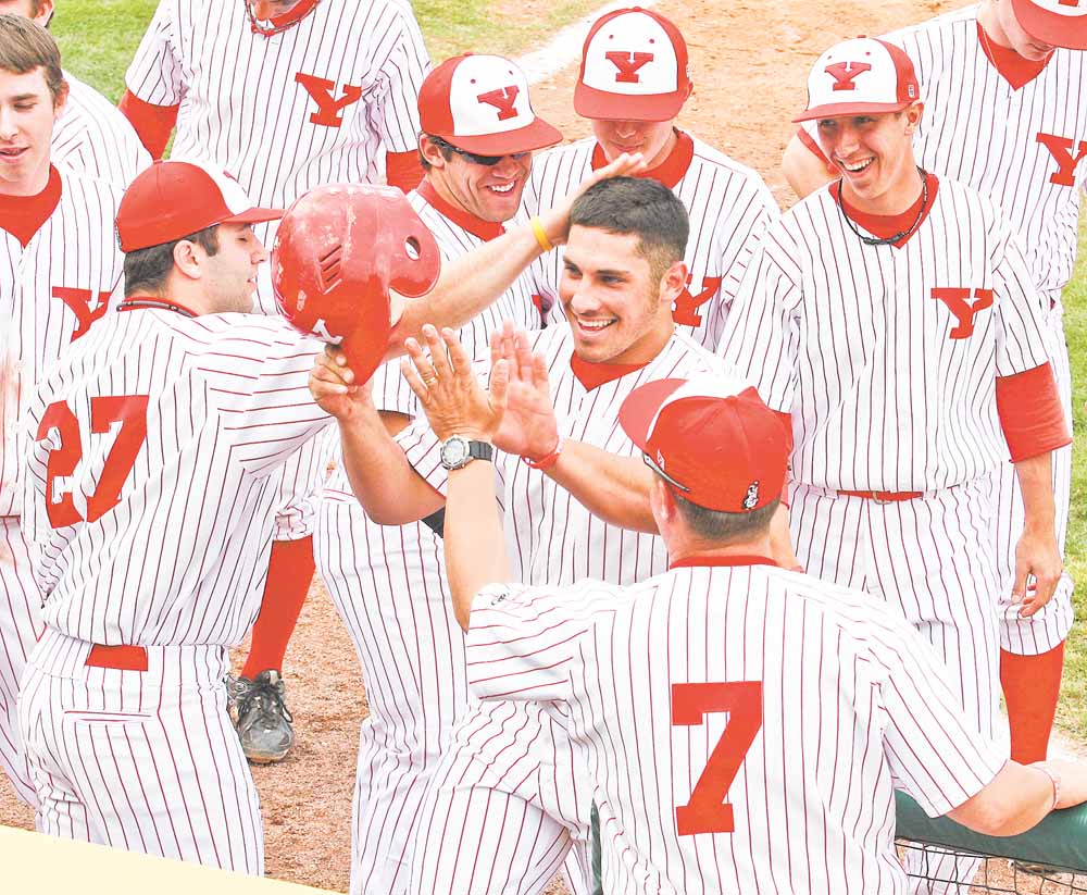 Youngstown State senior Joe Iacobucci is greeted at home plate by teammates after hitting a home run. Iacobucci and the Penguins finally get to play a home game March 22 at Eastwood Field against Penn State Behrend.