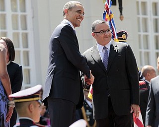 President Barack Obama shakes hands with El Salvador President Mauricio Funes during an arrival ceremony at the National Palace in San Salvador, El Salvador, Tuesday, March 22, 2011. 
