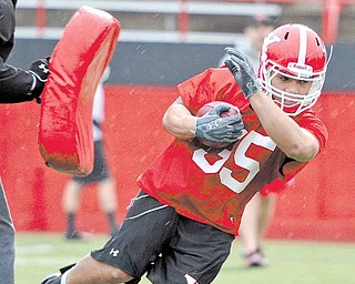 Youngstown State’s Jamaine Cook runs drills during the Penguins’ first spring practice Wednesday at YSU’s
Stambaugh Stadium. In coach Eric Wolford’s second spring opener, the team looked a lot more cohesive,
energetic and organized than last year.