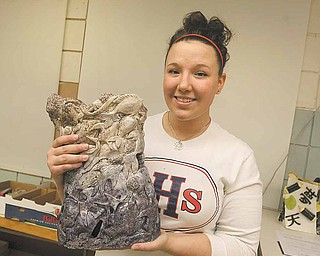 Fitch High School senior Amber Henik shows off her award-winning ceramics piece “Global Warming Kills More Than Polar Bears.” Her work will be on display in New York City at the World Financial Center’s courtyard gallery through June.