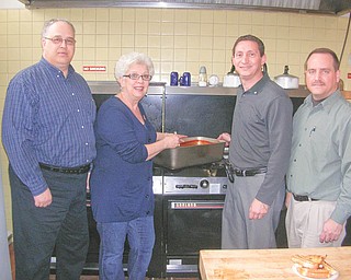 Here’s what’s cookin’: Involved in preparations for an annual spaghetti dinner to be sponsored by Struthers Rotary Club are, from left, Tom Baringer, dinner chairman; Mary Ann Morell, head chef; Don Gabriele, dinner co-chairman; and Bryan Higgins, club president. Assisting them at the event from 3 to 7 p.m. April 2 at St. Nicholas Social Hall, 765 Fifth St., Struthers, will be members of Struthers High School Interact Club and of Boy Scout Troop 101. Meals will be $6 for adults and $3 for children under 12 and proceeds will benefit local community projects.