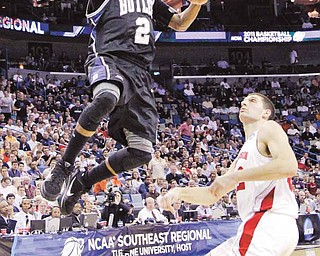 Butler's Shawn Vanzant (2) shoots in front of Wisconsin's Keaton Nankivil during the first half of the NCAA Southeast regional college basketball semifinal game Thursday, March 24, 2011, in New Orleans. (AP Photo/David J. Phillip)