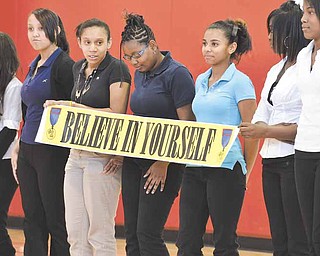 Members of an eighth-grade social studies class at Wilson Middle School help display a banner during a play called “K.C.’s Dream.” The play was part of the Black History Project presented Thursday at the Youngstown school on the city’s South Side.