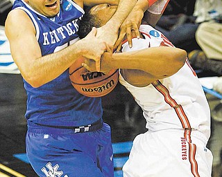 Kentucky's Josh Harrellson, left, fights for control of the ball with Ohio State's Jared Sullinger, right, during the first half of an an East regional semifinal game in the NCAA college basketball tournament Friday, March 25, 2011, in Newark, N.J. 