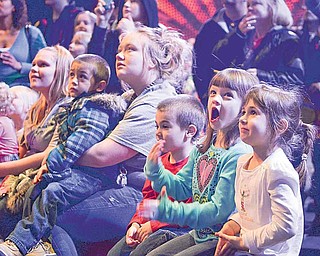 Travis Mills (red), 4, of Canfield, Caiden Smith (blue), 6, of Austintown, and DeeAnna Mills (white), 6, of Canfield, watch a pre-show perfomance Friday night at the Covelli Center.