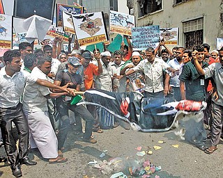 Sri Lankan Muslims burn an effigy of U.S. President Barack Obama during a protest rally against the allied forces' air strike in Libya, in Colombo, Sri Lanka, Friday, March 25, 2011. NATO's military staff is drawing up detailed plans to assume full control of the no-fly zone over Libya in coming days, after member nations agreed to take on the operation from a U.S.-led coalition. 
