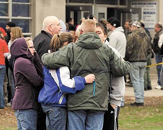 Parents and students gather after students were released following an early morning shooting at West Middle School in Martinsville, Ind., Friday, March 25, 2011. A gunman opened fire at the middle school before classes began Friday, shooting a student in the stomach, police said. A 15-year-old classmate who had been suspended was taken into custody. 