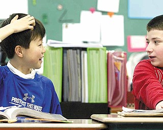 Sean Hiramatsu, 10, of Japan interacts with a classmate at McKinley Elementary School in Poland. Sean’s parents sent him to the Mahoning Valley after the earthquake and tsunami in Japan earlier this month. With Sean in math class is fellow fifth- grader Mark Pompeo.