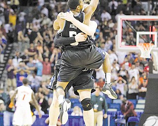 Butler's Ronald Nored (5) jumps into the arms of teammate Matt Howard after overtime of the NCAA Southeast regional college basketball championship game Saturday, March 26, 2011, in New Orleans. Butler won 74-71 to advance to the Final Four.