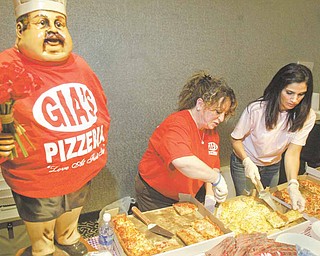 Lori Greenwalt, left, and Lynn Guerrieri of Gia’s Pizzeria in Boardman serve up their specialties during The Mahoning Valley Pizza Cook-off on Sunday.