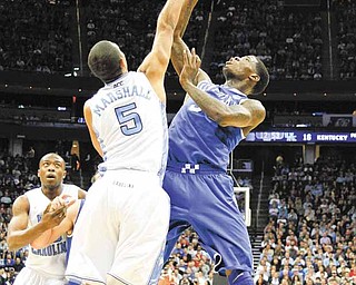 North Carolina's Kendall Marshall (05) contests the shot of Kentucky's DeAndre Liggins during first-half action in the men's NCAA East Regional Championship game on Sunday, March 27, 2011 at the Prudential Center in Newark, New Jersey.