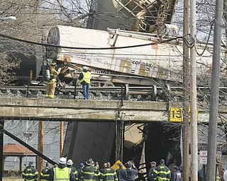 Firefighters and HAZMAT crews from Mahoning Trumbull and Portage county assess the damage Monday after a CSX train carrying ammonia and chlorine derailed near North Center Street in Newton Falls.