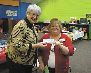 Breaking language barrier: Each year the Gamma Pi Chapter of Delta Kappa Gamma Sorority contributes funds to the English Center of Youngstown. Making the presentation at a recent meeting to Leslie Kiske of Poland, at left, is Betsey White, chapter president, also of Poland. The funds will be used to teach the English language to foreign-speaking adults who are studying to become American citizens. At the meeting Lana Whitehead of Canfield, coordinator and intervention specialist in the Center for Student Progress at Youngstown State University, explained the role of the center in promoting the academic success of YSU students.