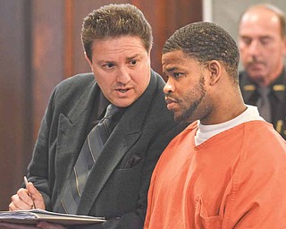 Defense lawyer Anthony Meranto, left, speaks to his client Michael Harsch, 26, of Warren at Harsch’s sentencing before Judge Maureen Sweeney of Mahoning County Common Pleas Court. The judge sentenced Harsch to 15 years in prison Wednesday for crimes committed against his former girlfriend in 2009.
