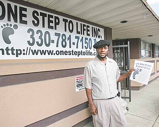 Glen Williams, executive director of One Step to Life, shows off a flier about one of the organization’s support programs. One Step had a ribbon-cutting ceremony Wednesday to show off its new offices on Midlothian Boulevard in Youngstown. One Step seeks to work with inner-city youths to stem crime and family violence