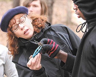 Roosevelt Cooper, right, holds a crayfish, while Holly Burnett-Hanley, coordinator of Mahoning River Education Project at Youngstown State University, shows a broken appendage on the creature. Roosevelt was one of many seventh-and eighth-graders in honors science at Volney Rogers Middle School who spent part of the school day Wednesday testing the water quality and analyzing insect life in the stream.