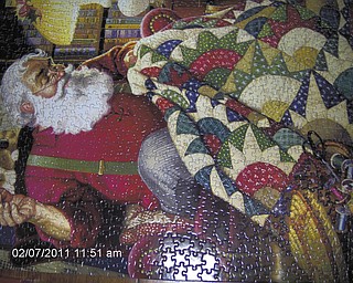While waiting for the arrival of spring, Pete Dumas of Austintown and his wife spend many hours putting together puzzles their family gave them for Christmas. Here's a 1,000-piece puzzle they did called "Santa Sewing."