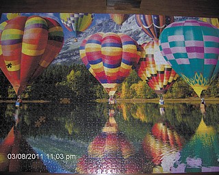While waiting for the arrival of spring, Pete Dumas of Austintown and his wife spend many hours putting together puzzles their family gave them for Christmas. Here's a 2,000-piece puzzle they did called "Balloons."