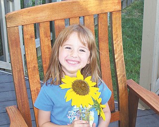 Riley Sweder of Columbus proudly shows off her own garden-grown sunflowers. Picture taken and sent in by her mom, Carolyn Sweder, a former New Middletown resident.