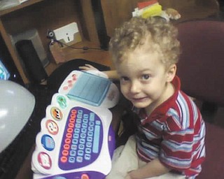 Timmy Kerr, 4, of Poland, plays with his computer while waiting for warmer weather. Photo sent in by Gary Kerr.