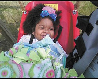 Dereon North of Campbell enjoys her new Jennswing for kids with disabilities.