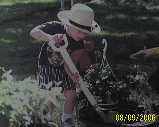 Grandma Judy snapped this shot of her grandson, Bryan, donning an authentic Amish hat while helping her plant flowers.