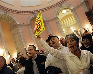 Protestors gather in the rotunda at the Ohio statehouse after Senate Bill 5 passed through the Ohio House of Representatives Wednesday, March 30, 2011, in Columbus, Ohio. The bill would strip public employees of collective bargaining rights.