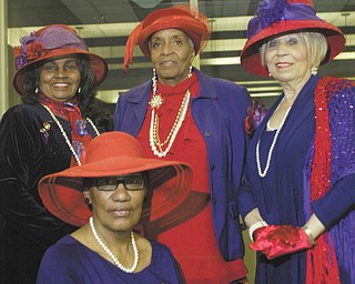 William D. Lewis | The Vindicator: Members of A String of Pearls, the local chapter of the Red Hat Society, show off their finery in anticipation of the upcoming International Red Hat Day Luncheon on April 20. Seated is Erma Hart, and standing, from left, are Anna Harrell, Tommicean Burney and Audrey Gillian.