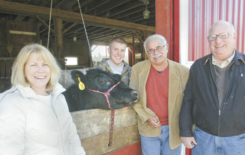 WILLIAM D. LEWIS | THE VINDICATOR: Preparing for the 22nd Annual Strimbu Memorial Barbecue are, from left, Nancy Lukasko, a committee member; a steer that will be auctioned as part of the event; Spencer Strimbu, a committee member; John “Chip” Mastrian, president of the Strimbu Memorial Fund; and Ed Wilson, a Strimbu board member. The event will take place May 4 at Yankee Lake Ballroom.