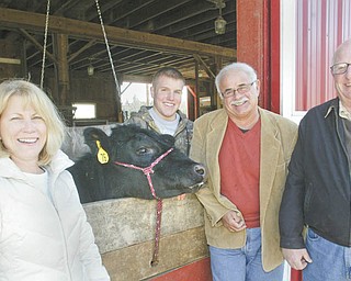 WILLIAM D. LEWIS | THE VINDICATOR: Preparing for the 22nd Annual Strimbu Memorial Barbecue are, from left, Nancy Lukasko, a committee member; a steer that will be auctioned as part of the event; Spencer Strimbu, a committee member; John “Chip” Mastrian, president of the Strimbu Memorial Fund; and Ed Wilson, a Strimbu board member. The event will take place May 4 at Yankee Lake Ballroom.