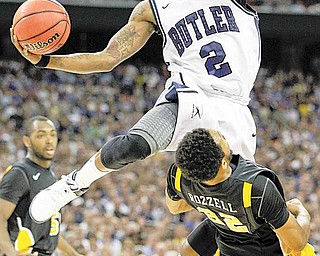 Butler's Shawn Vanzant (2) drives to the basket over Virginia Commonwealth's Brandon Rozzell during the first half of a men's NCAA Final Four semifinal college basketball game Saturday, March 2, 2011, in Houston.