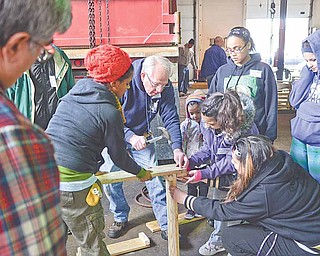 Bob McGowan of Youngstown, a member of the Men’s Garden Club of Youngstown, builds a tiered strawberry planter with community gardeners from St. Patrick Church on Saturday afternoon at Emch Spring Service in Youngstown.