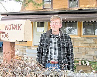 Warren Councilman Al Novak stands in front of his home on Bonnie Brae Avenue Northeast, the house he grew up in and where he has raised his family. He’s been a Warren councilman for 20 years and is finance-committee chairman for a city council with a $26 million general-fund budget. But he earns just more than $20,000 per year stocking shelves at Giant Eagle.