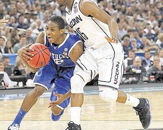 Kentucky's Brandon Knight battles past Connecticut defender Kemba Walker during the first half in the men's NCAA Final Four semifinals at Reliant Stadium in Houston, Texas, Saturday, April 2, 2011.