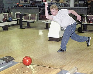 Chris Hood, a long-time employee at Kay Lanes in Girard, aims for the pins at the bowling alley which is closing. Hood started bowling there as a 7-year-old boy.
