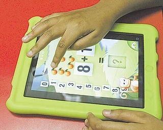 A student at the Rich Center for Autism at Youngstown State University uses an iPad application that teaches math.