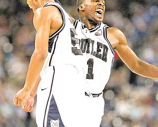 Shelvin Mack of Butler, right, celebrates during second-half action against Virginia Commonwealth in an NCAA Final Four semifinal at Reliant Stadium in Houston, Texas, Saturday, April 2, 2011. Butler beat VCU, 70-62.