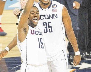 Kemba Walker, left, and Charles Okwandu of Connecticut celebrate a 56-55 victory over Kentucky in the men's NCAA Final Four semifinals at Reliant Stadium in Houston, Texas, Saturday, April 2, 2011.