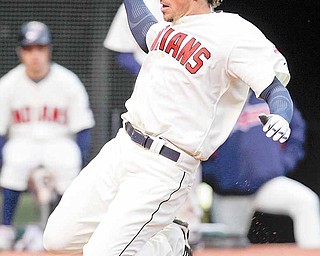 Cleveland Indians' Travis Buck slides home on a sacrifice fly by teammate Michael Brantley in the eighth inning in a baseball game against the Chicago White Sox, Sunday, April 3, 2011, in Cleveland. The Indians won 7-1.