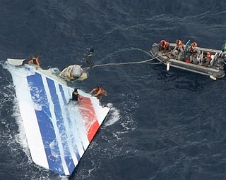 In this Monday, June 8, 2009 file photo released by Brazil's Air Force, Brazil's Navy sailors recover debris from the missing Air France Flight 447 in the Atlantic Ocean. Undersea robots have located a "large part" of an Air France jet that plunged into the Atlantic Ocean in 2009, but haven't yet found its black box flight recorders, French officials said Monday April 4, 2011. Victims' families cautiously welcomed the surprise announcement that search teams have located pieces of the plane, after nearly two years of fruitless efforts to determine what caused it to crash. Investigators have said without the recorders, the cause may never be determined.
