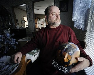 In this March 8, 2011 photo, Gary Quarles holds a helmet made in memory of his son Gary Wayne Quarles at his home in Naoma, W.Va. Gary Wayne Quarles and 28 other men died deep inside Massey Energy's Upper Big Branch mine on April 5, 2010 near Montcoal. It was the deadliest U.S. coal mining accident since 1970, and remains the target of civil and criminal investigations.