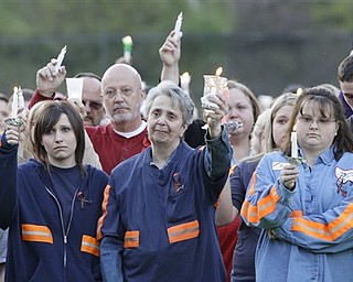 In this file April 10, 2010 file photo, people from the coal mining towns along the Coal River participate in a memorial vigil in Naoma, W.Va., for 29 miners who died in the explosion at Massey Energy Co.'s Upper Big Branch mine in Montcoal, W.Va. A year since the disaster, Massey Energy company and their CEO Don Blankenship, " King of Coal" , are no longer around.