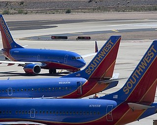 A Southwest Airlines jetliner maneuvers around the tarmac at Phoenix Sky Harbor International Airport on Monday, April 4, 2011 in Phoenix. The peeling away of a 5-foot-long hole recently on a Southwest Jet as the plane traveled at 35,000 feet raised questions about how vulnerable the world’s passenger air fleet is to similar cracks, and federal aviation officials were considering ordering more widespread inspections.