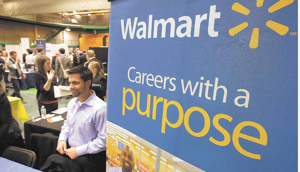 In this March 4, 2011 photo, representatives from Walmart speak to job seekers at the 32nd Annual Spring Career Fair at Cleveland State University. Over 120 organizations were on hand to talk to prospective candidates about employment and internships.
